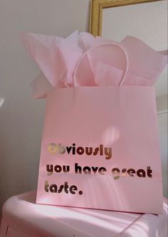 a pink shopping bag sitting on top of a pile of luggage with the words, seriously you have great taste