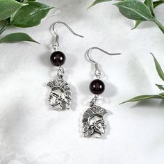 These Ares earrings are the perfect accessory to show your love for the Greek gods in a subtle way! Made with garnet gemstone and a Spartan soldier charm.  Made with hypoallergenic fishhook style earrings. Two options are available: Stainless Steel Silver Plated Brass Ships in a jewelry box so it's ready to be give as a gift. All materials are lead and nickel free. Charm is made with zinc alloy.  Earrings will be disinfected before shipment but should also be cleaned every time before wearing. Greek God Jewelry, Greek Mythology Earrings, God Greek Mythology, Spartan Soldier, Greek Mythology Jewelry, Mythology Jewelry, The Greek Gods, Alloy Earrings, Greek God