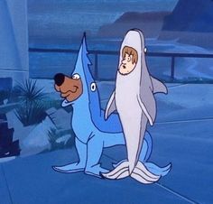 the shark and dog are standing next to each other in front of an ocean background