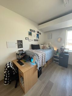 a bed room with a neatly made bed and desk