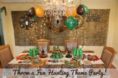 there is a table that has balloons and decorations on it with the words throw a fun hunting theme party