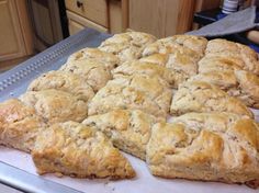 freshly baked biscuits sitting on top of a cookie sheet