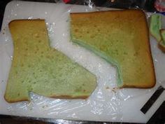 two pieces of toast sitting on top of a white cutting board