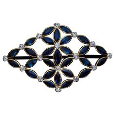 a brooch with blue and white stones on it