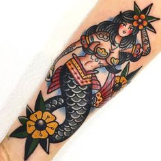 a woman is sitting on top of a fish with flowers in her hair and holding an umbrella