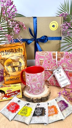 a coffee mug sitting on top of a wooden table next to two packages of coffee