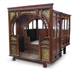 an ornate wooden display case with carved doors