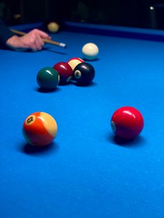 billiards and pool balls on a blue table