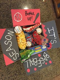 some signs that are on the ground with food in them and candy bar sign next to it