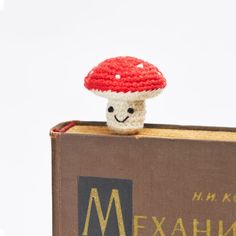 a crocheted mushroom sitting on top of a book with the title mexahn written below it