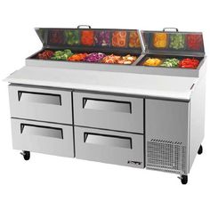 two refrigerated buffets with trays full of fresh fruits and vegetables