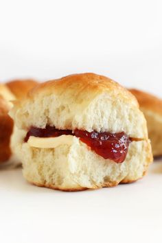 a close up of a pastry with jelly on it and the words vegan dinner rolls