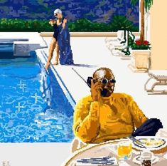 a man sitting in front of a pool talking on a cell phone next to a woman