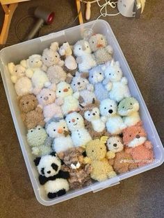 a plastic container filled with lots of stuffed animals