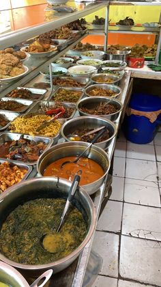 a buffet filled with lots of different types of food on top of metal pans