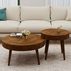 two wooden tables sitting on top of a white rug