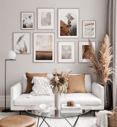 a living room filled with furniture and pictures on the wall above it's coffee table