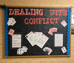 a bulletin board with writing on it that says dealing with conflict and diced up playing cards