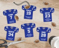 blue football jersey cutouts with scissors and rope on the table next to it are numbered for each player