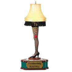 a lamp that has a woman's legs and stockings on it with the words, it's a wonderful day beautiful