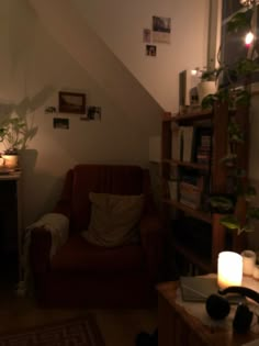 a living room filled with furniture and a book shelf next to a lamp on top of a table