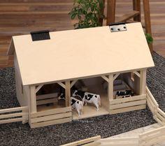 Looking for a barn to compliment your child's toy animals set? Here it is! This classy wood barn toy is ready to delight your kids with features galore. The wooden A-Frame Barn is hand-crafted in Shipshewana, Indiana by Amish Craftsmen. It is designed to fit animals from 5" to 7.5" tall. With its classic A-Frame style and opening roof this barn allows easy access to the interior. There is a sliding haymow in the top half of the barn to store feed for the animals; the height from the floor to the Wooden Toy Barn, Kids Barn, Shipshewana Indiana, Hay Loft, Showroom Decor, Toy Barn, Farm Projects, Wooden Barn, Wood Barn