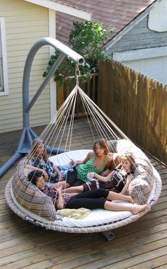 a group of people sitting in a hammock