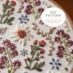 an embroidery project with flowers and leaves on it