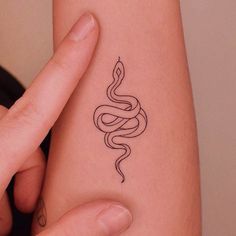 a woman's arm with a snake tattoo on the left side of her body