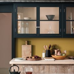 a kitchen counter with dishes and utensils on it