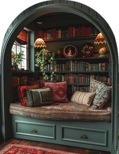 a room with bookshelves, couch and rugs