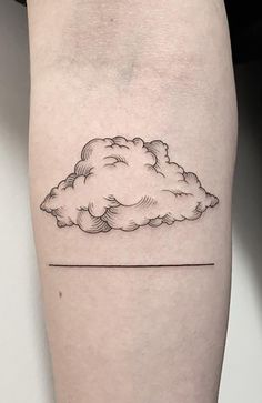 a small cloud tattoo on the arm