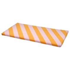 an orange and pink striped pillow on a white background