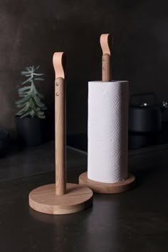 two wooden toothbrush holders sitting on top of a counter