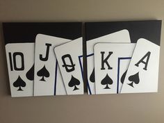 four playing cards are displayed on the wall