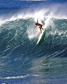 a person on a surfboard riding a wave