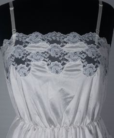 Here's a sweet and lovely vintage camisole you'll adore. This late 70s / 80s crossover brand cami has an original Ashley Taylor label and great boho style. You'll love feeling groovy in this hourglass top and you'll love wearing it with your other period collectibles. This figure-flattering ivory colored, lace trimmed camisole top is in excellent condition with signs of wear/use and portion of stretched waistband that still works and stretches in and out just fine - see last close up picture. Th Vintage Fitted Sleeveless Camisole, Vintage Lace Trim Camisole Tank Top, Vintage Lace Trim Tank Top, Vintage Lace Trim Camisole Top, Vintage Fitted Tank Top With Spaghetti Straps, Fitted Vintage Tank Top With Spaghetti Straps, Vintage Sleeveless Camisole With Built-in Bra, Vintage Camisole Top For Daywear, Vintage Cami Tank Top With Lace Trim