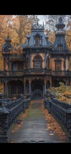 an old house in the fall with leaves on the ground and stairs leading to it