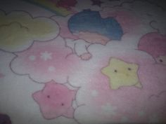 a child's bed with teddy bears and clouds on it