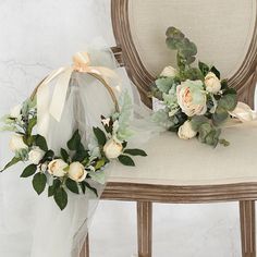 two wedding bouquets sitting on top of a chair