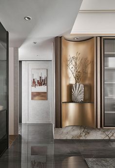 an elegant hallway with marble floors and gold wall paneling, along with art work on the walls