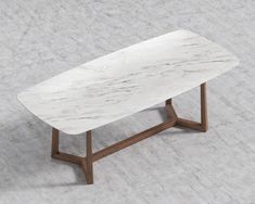 a white marble coffee table with wooden legs