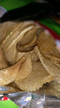 a pile of potato chips sitting on top of tin foil