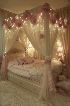 a canopy bed with pink and white curtains on it's sides, surrounded by lights