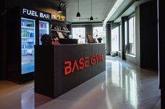 the interior of a fuel bar with neon signs on the front and back wall,