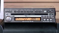 an old radio sitting on top of a table next to a wall with a clock