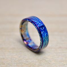 a blue ring sitting on top of a wooden table