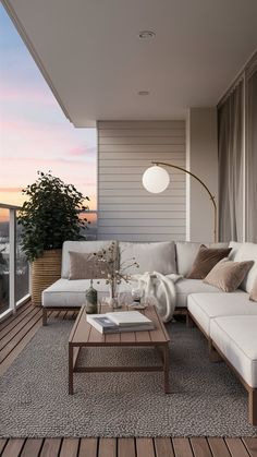 a living room filled with furniture on top of a wooden floor next to a window