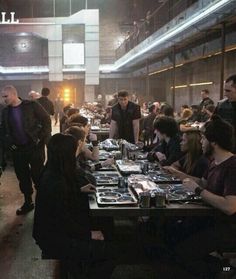 a group of people sitting at tables in a building