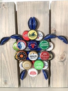 a wooden wall with several different types of beer bottle caps on it